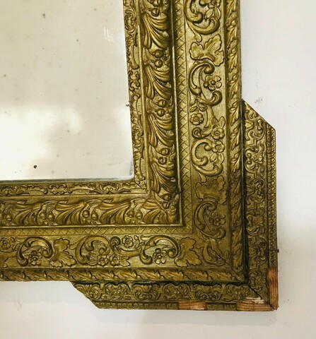 miroir en stuc à coquille patine bronze décor floral fond en sapin . XX siècle .