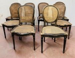 suite de huit chaises en bois patiné assises dossier cannage . XX siècle .