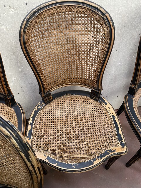 suite de huit chaises en bois patiné assises dossier cannage . XX siècle .