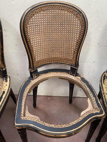 suite de huit chaises en bois patiné assises dossier cannage . XX siècle .