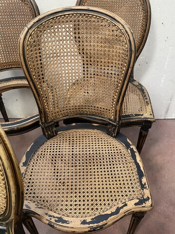 suite de huit chaises en bois patiné assises dossier cannage . XX siècle .