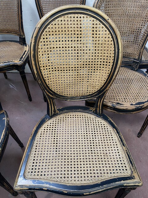 suite de huit chaises en bois patiné assises dossier cannage . XX siècle .